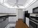 Updated kitchen with white cabinets, black granite countertops, and stainless steel appliances at 1946 Cove Pointe Dr, Venice, FL 34293