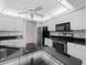 Bright kitchen with white cabinets, dark granite counters, and stainless steel appliances at 1946 Cove Pointe Dr, Venice, FL 34293