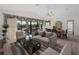Living room with view of the pool through sliding glass doors and a dining area at 1946 Cove Pointe Dr, Venice, FL 34293