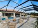 Screened-in patio featuring a fire pit, seating area, and view of the pool at 1946 Cove Pointe Dr, Venice, FL 34293