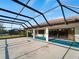 Covered pool and patio area with view of the surrounding landscape at 1946 Cove Pointe Dr, Venice, FL 34293