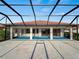 Screened lanai and pool with view of the home's exterior at 1946 Cove Pointe Dr, Venice, FL 34293