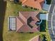 Top-down view of a home with a tile roof, screened lanai, and backyard at 1946 Cove Pointe Dr, Venice, FL 34293