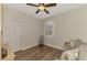 Spacious bedroom with wood flooring and a ceiling fan at 2459 Sherman Oak Dr, North Port, FL 34289