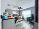 Main bedroom with gray walls, a queen-size bed and a work desk at 27240 Tribune Blvd, Punta Gorda, FL 33955