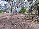 View of cleared lot with a house in the background at 27240 Tribune Blvd, Punta Gorda, FL 33955