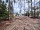 View of cleared lot with a house in the background at 27240 Tribune Blvd, Punta Gorda, FL 33955