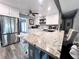 Modern kitchen with white cabinets, granite countertops, and stainless steel appliances at 27240 Tribune Blvd, Punta Gorda, FL 33955