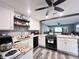 Modern kitchen with white cabinets, granite countertops, and stainless steel appliances at 27240 Tribune Blvd, Punta Gorda, FL 33955