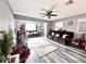 Open concept living area with hardwood floors, large windows, and comfy seating at 27240 Tribune Blvd, Punta Gorda, FL 33955