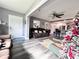 Open concept living room and kitchen with gray walls and wood-look floors at 27240 Tribune Blvd, Punta Gorda, FL 33955