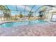 Inviting screened pool with brick pavers and canal views at 2842 Sancho Panza Ct, Punta Gorda, FL 33950