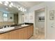 Double vanity bathroom with granite countertop, large mirror, and separate shower and toilet at 3340 Wood Thrush Dr # 323, Punta Gorda, FL 33950