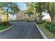 Condo building entrance with palm trees and landscaping at 3340 Wood Thrush Dr # 323, Punta Gorda, FL 33950