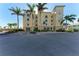 Condo building exterior with palm trees and parking area at 3340 Wood Thrush Dr # 323, Punta Gorda, FL 33950