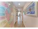 Long hallway with hardwood floors and vintage map decor at 3340 Wood Thrush Dr # 323, Punta Gorda, FL 33950