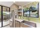 Kitchen boasts a farmhouse sink and opens to a balcony with water views at 3340 Wood Thrush Dr # 323, Punta Gorda, FL 33950