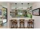 Stylish kitchen with breakfast bar and green backsplash at 3340 Wood Thrush Dr # 323, Punta Gorda, FL 33950
