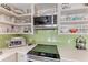 Well-equipped kitchen with ample shelving and a light green backsplash at 3340 Wood Thrush Dr # 323, Punta Gorda, FL 33950
