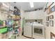 Laundry room with washer, dryer, and ample storage shelving at 3340 Wood Thrush Dr # 323, Punta Gorda, FL 33950