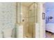 Shower with glass enclosure and decorative wallpaper at 3340 Wood Thrush Dr # 323, Punta Gorda, FL 33950