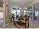 Cozy breakfast nook with a round table, sliding glass doors, and tranquil views of the outdoor pool at 3730 Whippoorwill Blvd, Punta Gorda, FL 33950