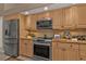 Well-equipped kitchen featuring stainless steel appliances, wooden cabinetry, and granite countertops at 3730 Whippoorwill Blvd, Punta Gorda, FL 33950