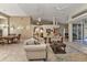 Bright and open living room with tile flooring, high ceilings, and a seamless flow to the dining area at 3730 Whippoorwill Blvd, Punta Gorda, FL 33950