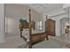 Spacious main bedroom features a four poster bed, armoire and tile floors at 3730 Whippoorwill Blvd, Punta Gorda, FL 33950