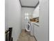 Bright laundry room with washer, dryer, and ample cabinet space at 3730 Whippoorwill Blvd, Punta Gorda, FL 33950