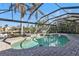 Inviting screened pool with waterfall feature and canal views at 3730 Whippoorwill Blvd, Punta Gorda, FL 33950