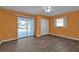 Bedroom with wood-look floors, sliding doors to patio, and ceiling fan at 412 Scarlet Sage, Punta Gorda, FL 33955