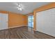 Bedroom with wood-look floors, double door closet and access to patio at 412 Scarlet Sage, Punta Gorda, FL 33955