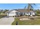 Front view of single-story house with driveway and landscaping at 412 Scarlet Sage, Punta Gorda, FL 33955