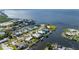 Beautiful waterfront home featuring boat dock, lush landscaping, and water views at 4431 Gardner Dr, Port Charlotte, FL 33952
