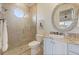 Bathroom features a walk-in shower, a sink with granite countertop, and a decorative mirror at 4431 Gardner Dr, Port Charlotte, FL 33952