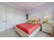 Comfortable bedroom features ample storage, side table, and bed adorned with decorative pillows and blanket at 4431 Gardner Dr, Port Charlotte, FL 33952