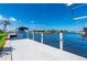 Long dock for boating featuring other houses in the background at 4431 Gardner Dr, Port Charlotte, FL 33952