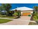 Charming single-Gathering home with a brick paved driveway and well-maintained landscaping with palm trees at 4431 Gardner Dr, Port Charlotte, FL 33952
