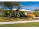 Inviting two-story home with a lush front yard and a brick-paved driveway at 4431 Gardner Dr, Port Charlotte, FL 33952