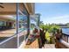 View of the home exterior featuring a covered pool and an expansive view of the canal from the porch at 4431 Gardner Dr, Port Charlotte, FL 33952