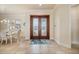 Elegant foyer with double doors, tile flooring, and adjacent dining area at 4431 Gardner Dr, Port Charlotte, FL 33952