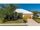 Charming home with a well-manicured lawn, brick driveway, and attached two-car garage in a sunny neighborhood at 4431 Gardner Dr, Port Charlotte, FL 33952