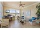 Home office featuring a ceiling fan, tile flooring, and large windows that provide plenty of natural light at 4431 Gardner Dr, Port Charlotte, FL 33952