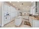 Open kitchen layout with tile flooring, center island, and stainless steel appliances at 4431 Gardner Dr, Port Charlotte, FL 33952