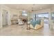 Living room with tile floors, stone fireplace, and access to the lanai at 4431 Gardner Dr, Port Charlotte, FL 33952