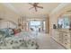 Spacious main bedroom with plush carpeting and an outdoor view of a lanai and a pool at 4431 Gardner Dr, Port Charlotte, FL 33952