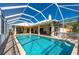 Spacious screened-in pool with a brick-paved patio area, complemented by outdoor ceiling fans at 4431 Gardner Dr, Port Charlotte, FL 33952