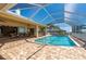 Enclosed pool featuring brick-paved patio, ample seating, and screen enclosure allowing natural light and clear skies at 4431 Gardner Dr, Port Charlotte, FL 33952