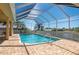 Backyard pool is fully screened-in, overlooking a waterfront view at 4431 Gardner Dr, Port Charlotte, FL 33952